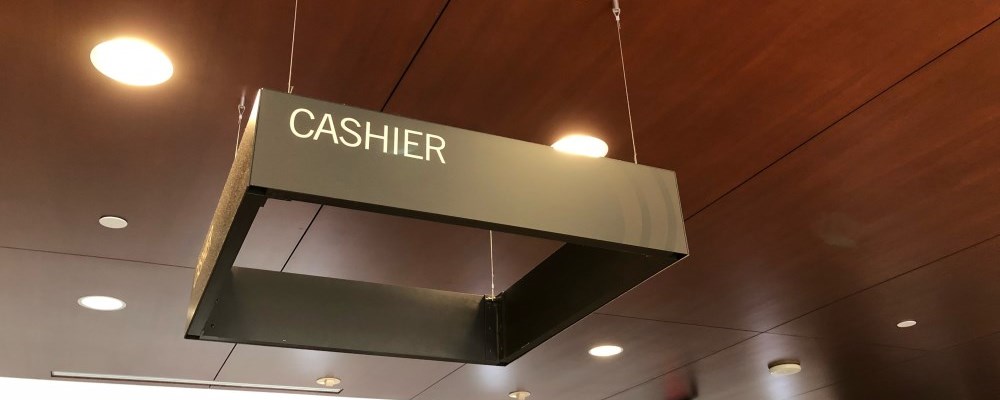 Cashier sign at the front counter of Durham Region Headquarters