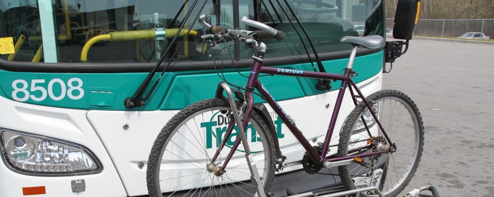 Bike on a bike rack on the front of a bus